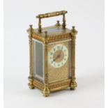 A French brass carriage clock, the case with fluted columns with pierced floral bands to top and