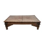 Large Indian low table with planked top and metal bolts on turned supports W190 x D112 x H51cms