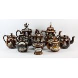 Seven Barge ware teapots, 19th Century, of typical design with brown treacle glaze and lids with