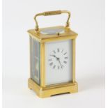 A French repeating brass carriage clock, late 19th Century, with white enamel dial with Roman