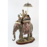 A Lladro Limited edition of an elephant, with a driver and two ladies, under a parasol,