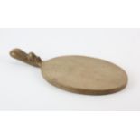 ROBERT 'MOUSEMAN' THOMPSON (BRITISH, 1876-1955), an oak cheese board, 38cm long x 18.5cm wide