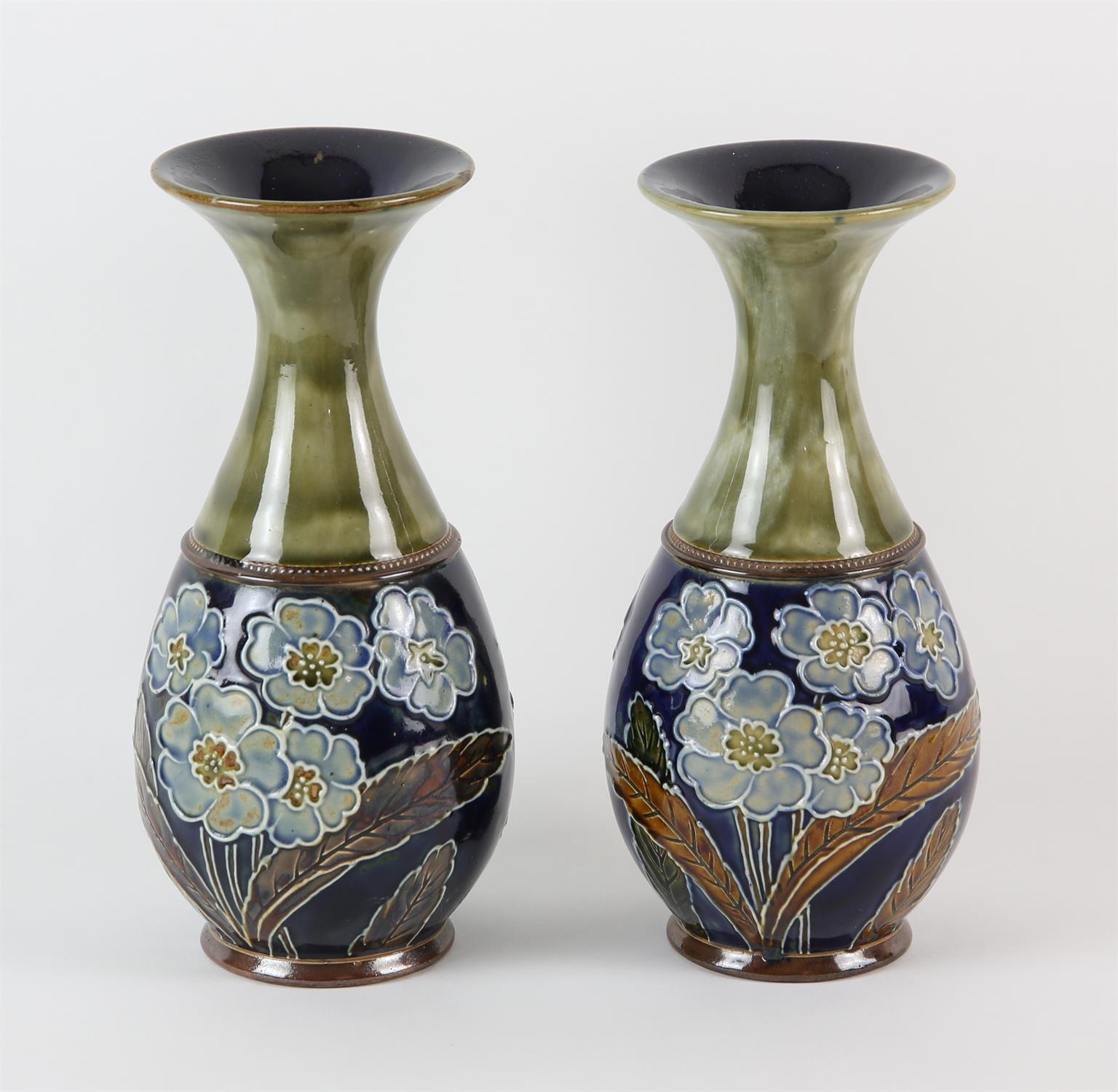 ROYAL DOULTON, a pair of vases decorated with tube lined flowers by Emily J Partington, 22cm high,