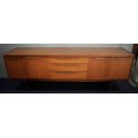 BEAUTILITY, a teak sideboard, with three central drawers, flanked by cupboards with shelves,
