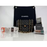 Amended description. CHANEL JUMBO classic flap bag in quilted black lambs leather with gold tone
