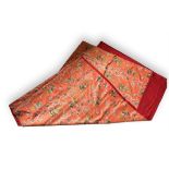 A large quantity of fine floral brocaded salmon pink silk fabric in seven sections in the form of a