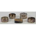 Three assorted silver napkin rings and two silver plated napkin rings
