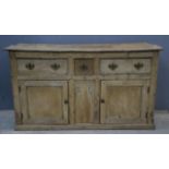 Pine dresser base, 19th Century, three short drawers, with two panelled doors, on plinth base,