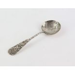 Oriental silver white metal tea caddy spoon with organic forms with stem decorated with flora,