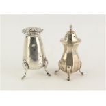 Two silver pepper pots of differing designs, Birmingham 1912 and Sheffield 1914