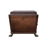 A Regency mahogany sarcophagus form wine cooler, with lions mask handles to the sides and a