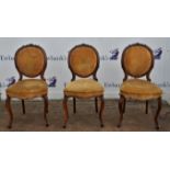 Three 19th century walnut dining chairs with stuffed backs and seats on cabriole legs and an early