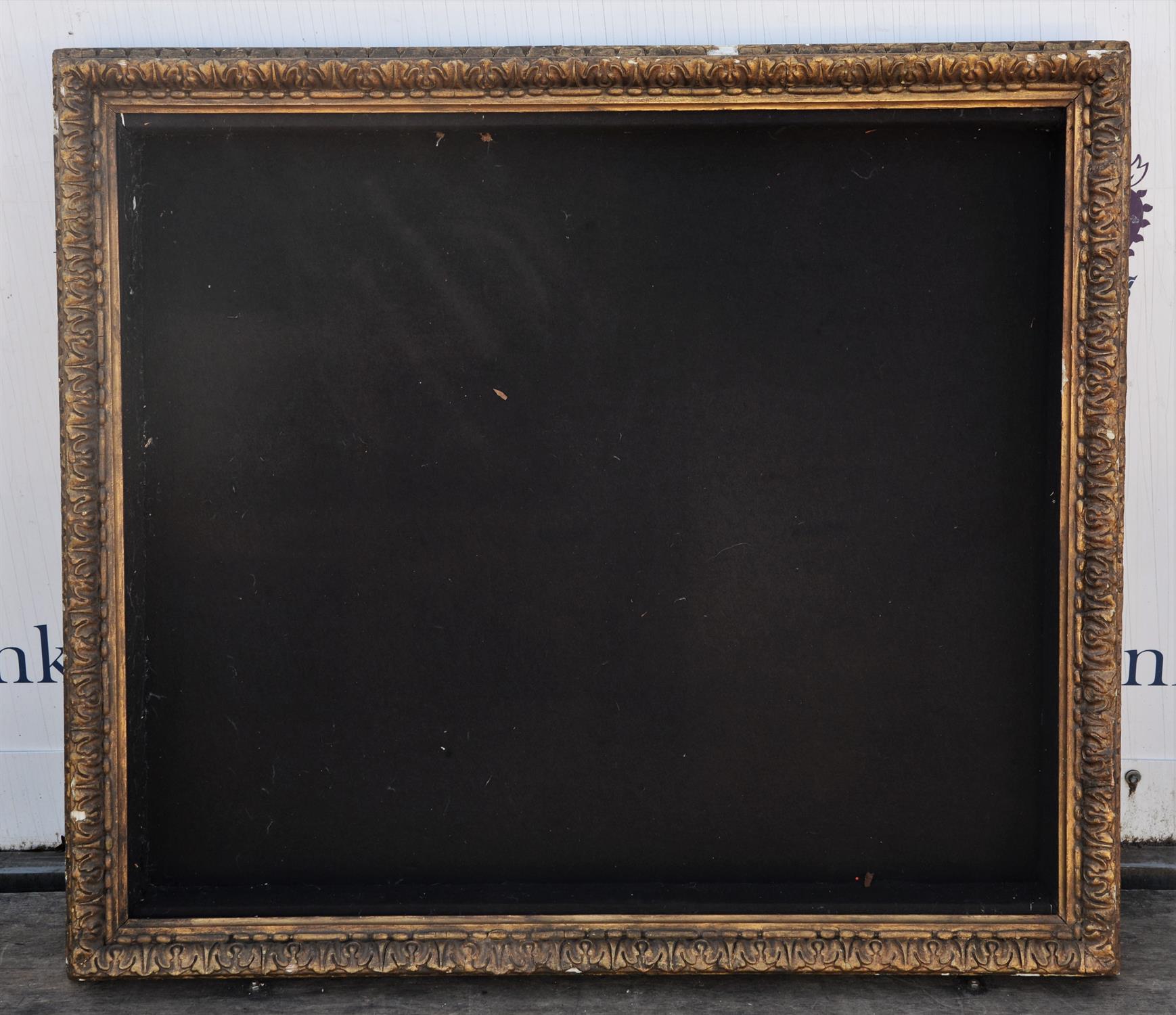 A large giltwood and gesso frame, converted to a display case, moulded with stiff leaves,