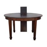 A mahogany oval extending dining table raised on square tapering supports terminating in spade feet.
