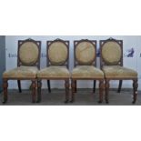 A set of four Victorian chairs, with carved top rails, above rectangular backs with oval cushions,