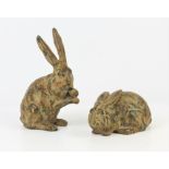 A pair of bronze models of hares or rabbits, 20th century, one seated, 19cm high (2)