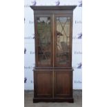 A mahogany display cabinet, 19th Century and later, the upper section with glazed doors enclosing