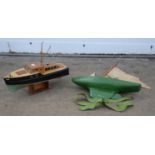 A plywood model of a boat, Beta, with cabin and electric motor, on stand, 43.5cm long,