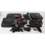 A large assortment of unboxed consoles, plugs, cables and accessories for various Sega systems