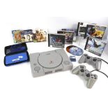 Sony PlayStation with controllers and games & Nintendo 3DS XL with case and games.