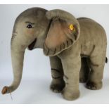 Large Steiff baby Elephant. Made from soft woven fur in grey. Stands at 75cm tall,