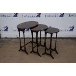 A nest of three mahogany tables, 20th Century, two with oval tops, on turned legs,