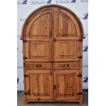 A fruitwood domed cupboard, 20th Century, with panelled doors above two frieze drawers,