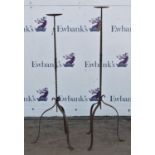 Pair of wrought iron candle stands, with writhen stems, on tripod feet, 129cm high (2)