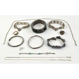 A selection of silver jewellery including two gate bracelets, two plain bangles, a bangle set with