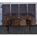 A Victorian mahogany extending dining table, on facetted baluster legs with casters,