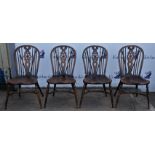 Set of four elm hoop back chairs, with back spindles and wheel pierced splats, on contoured seats