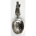 Edwardian silver caddy spoon with handle in the form of a maid holding two birds . Imported,