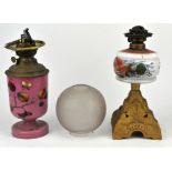 Seven oil lamps, late 19th/20th century, with a collection of glass shades and chimneys.
