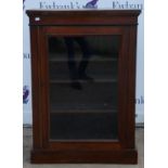 A Victorian walnut pier cabinet, with single glazed door, enclosing shelves, on plinth base,