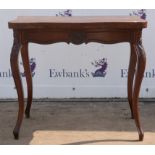 Continental style mahogany serpentine foldover table, late 19th Century, with foliate carved