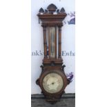An Edwardian oak aneroid barometer, the case with ornate architectural case, 124cm high