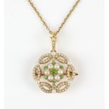 A pearl and demantoid garnet openwork pendant brooch, with central floral motif set with round cut