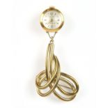 Emka, a gold pendant watch the signed dial with baton hour markers, and gold hands,