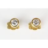 Diamond stud earrings, round brilliant cut diamond weighing an estimated 0.25 carats bezel set to