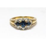 Sapphire and diamond cluster ring, three central sapphires surrounded by diamonds in a cluster