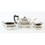 Three piece compressed oval fluted silver tea service Birmingham 1902, engraved with a family crest