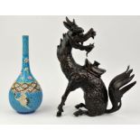 A Japanese figure of a Kirin, looking backwards at its tail, modelled as an incense burner with