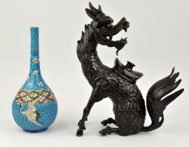 A Japanese figure of a Kirin, looking backwards at its tail, modelled as an incense burner with