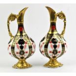A Pair of Royal Crown Derby 1128 Old Imari Swan Neck ewers, with solid gold banding,