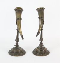 Pair of French bronze candlesticks, each with drinking horn sconces, on baluster stems,