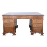 Mahogany partners desk, early 20th century, the top inset with a tooled leather writing surface