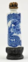 A blue and white Chinese snuff bottle with unglazed base, decorated with a coiled,