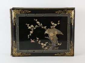 A Japanese kuro-nuri covered postcard album, 35 x 28 cm, Meiji Period; together with a lacquered