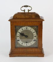 A walnut bracket clock, in the 18th Century style, with silvered Roman numeral chapter ring,