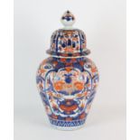 A Japanese Imari oviform vase with domed cover and knop finial, decorated with bold floral designs,